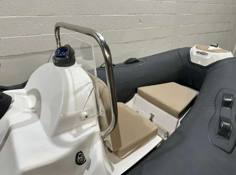 Slide: The Image of 2024 Apex A-12 Deluxe Tender with cushioned seating and sleek design in a modern setting. - 6