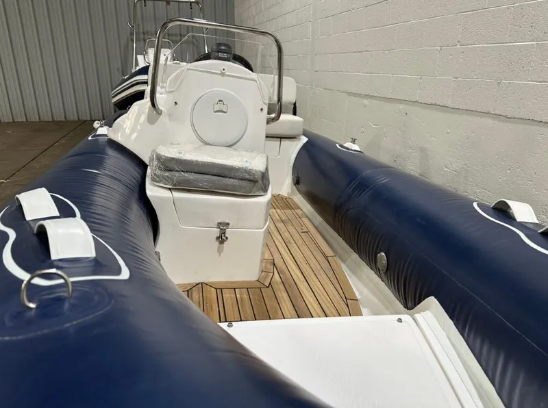 Slide: The Image of 2024 Apex A-13 Deluxe Tender with blue inflatable sides and wooden deck. - 4