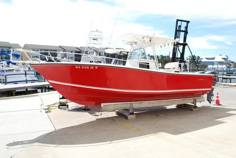 The Image of 1996 Regulator 26 Classic red boat on a dock, marina background. - 0