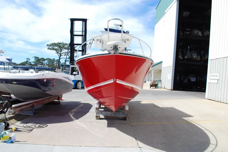 Slide: The Image of Red 1996 Regulator 26 Classic boat docked at a marina. - 14