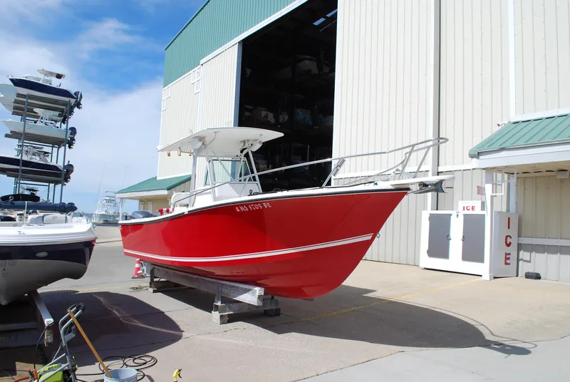 Slide: The Image of 1996 Regulator 26 Classic boat in red, docked at a marina. - 15