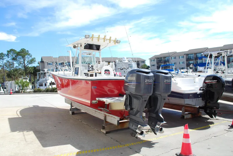 Slide: The Image of Red 1996 Regulator 26 Classic boat with twin Yamaha 250 engines in a marina. - 16