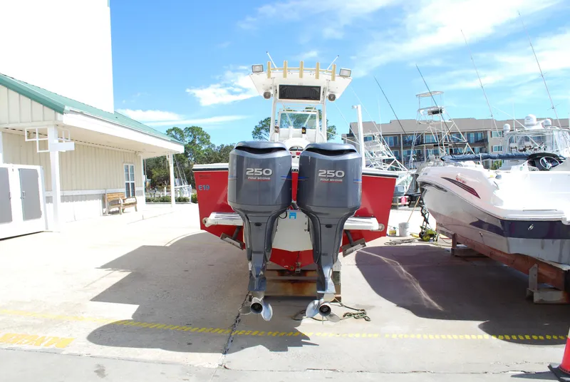 Slide: The Image of 1996 Regulator 26 Classic boat with twin 250 horsepower engines at a marina. - 17
