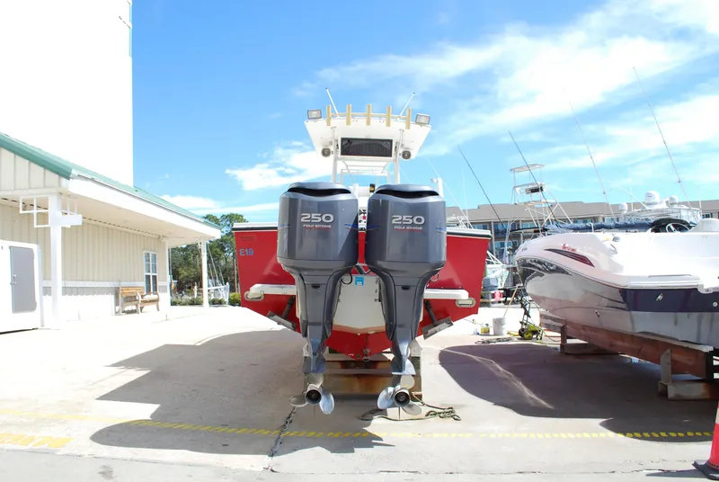 Slide: The Image of 1996 Regulator 26 Classic boat with twin 250 horsepower engines at a marina. - 18