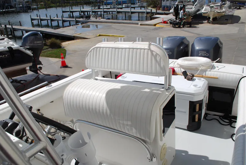 Slide: The Image of 1996 Regulator 26 Classic boat with twin Yamaha 250 engines docked at a marina. - 24