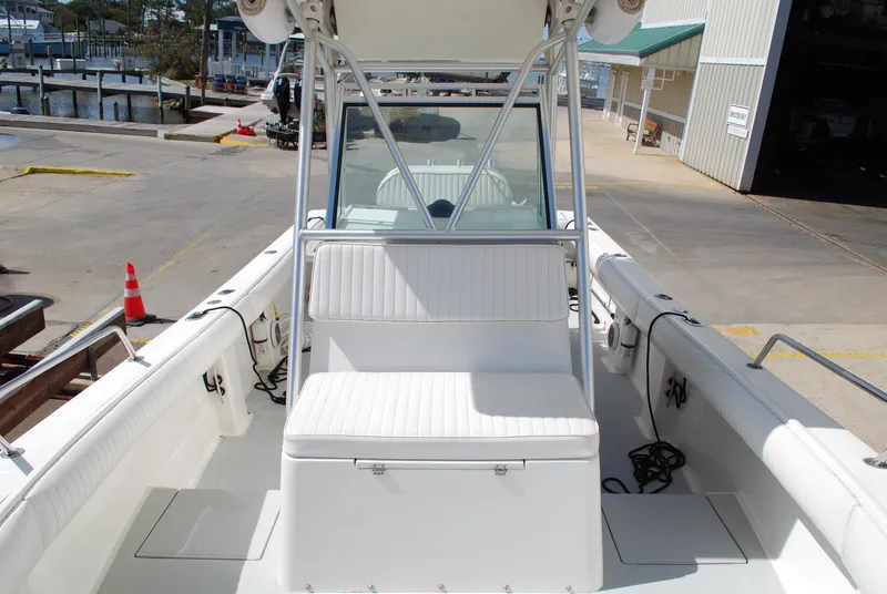 Slide: The Image of 1996 Regulator 26 Classic boat interior with white seating and storage. - 27