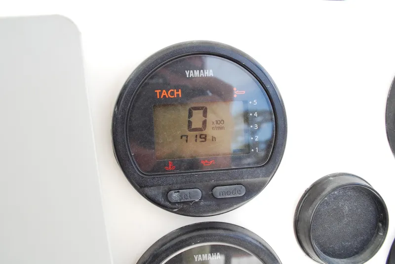 Slide: The Image of Yamaha tachometer on a 1996 Regulator 26 Classic boat dashboard. - 31