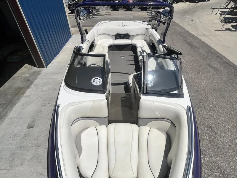 Slide: The Image of 2007 Malibu 247 LSV boat interior with white seating and open windshield. - 10