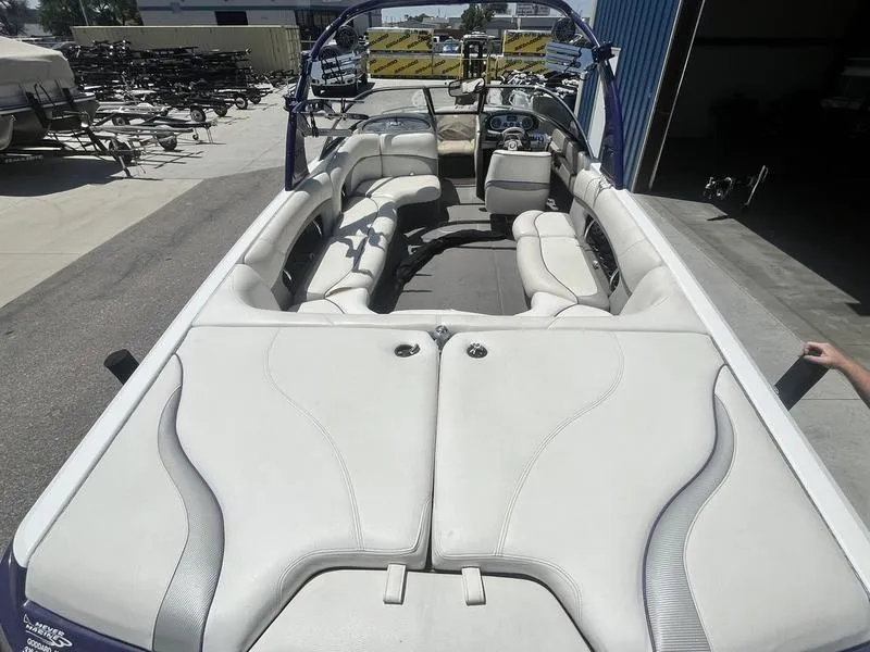 Slide: The Image of 2007 Malibu 247 LSV boat interior with white and gray seating. - 11