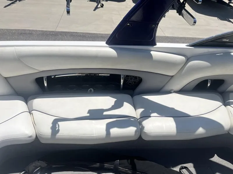 Slide: The Image of 2007 Malibu 247 LSV boat interior with white leather seating. - 14