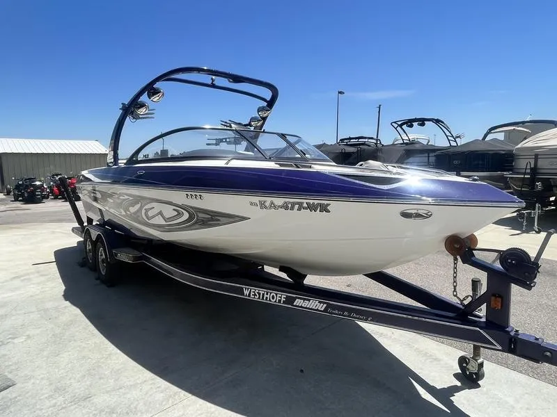 Slide: The Image of 2007 Malibu 247 LSV boat on trailer in outdoor storage area. - 5