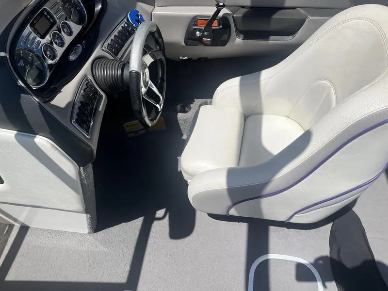Slide: The Image of 2007 Malibu 247 LSV boat interior with steering wheel and captain's chair. - 8