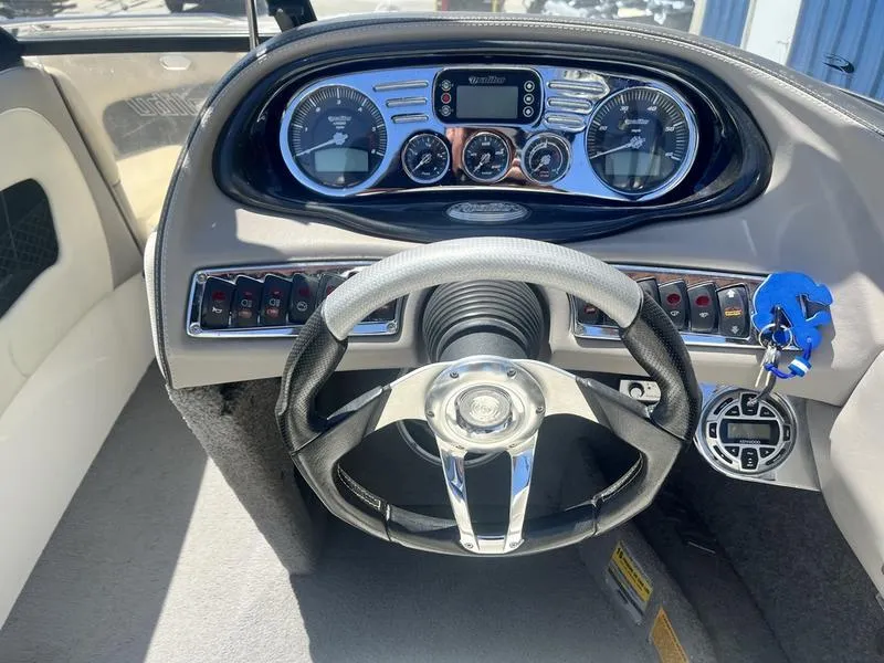 Slide: The Image of 2007 Malibu 247 LSV boat dashboard with steering wheel and instrument panel. - 9