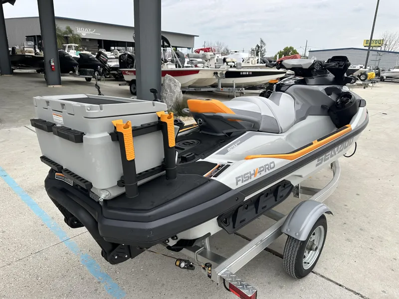 Slide: The Image of 2023 Sea-Doo Fish/Pro jet ski on trailer, equipped with fishing gear and storage box. - 4