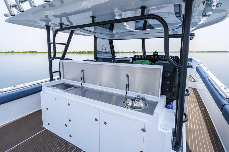 Slide: The Image of 2025 Custom SilverCAT 40CC boat with sleek outdoor kitchen and sink on deck. - 10