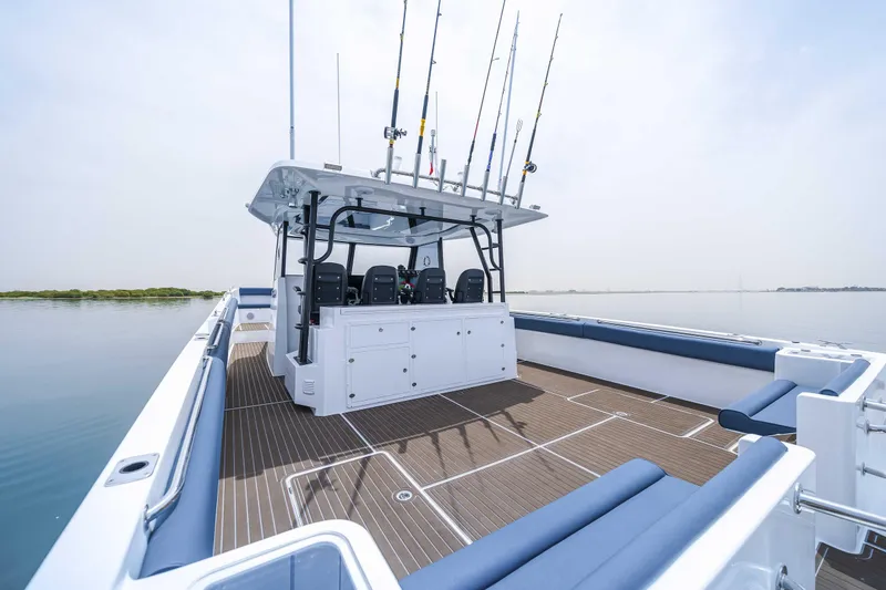 Slide: The Image of 2025 Custom SilverCAT 40CC boat with fishing rods on a calm water body. - 12