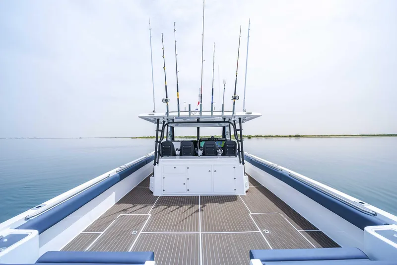 Slide: The Image of Custom SilverCAT 40CC 2025 boat with fishing rods on calm water. - 14