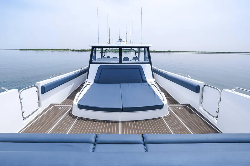 Slide: The Image of 2025 Custom SilverCAT 40CC boat with spacious deck and blue seating on calm water. - 17