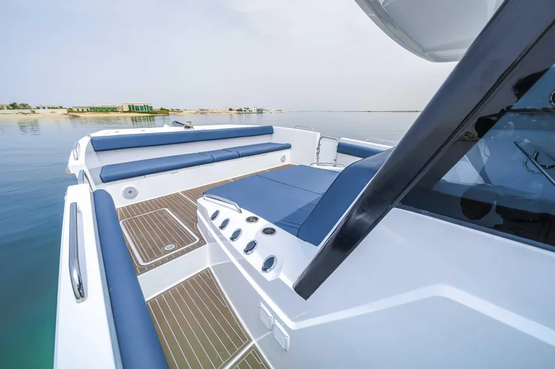 Slide: The Image of 2025 Custom SilverCAT 40CC boat with sleek design and blue seating on calm water. - 18