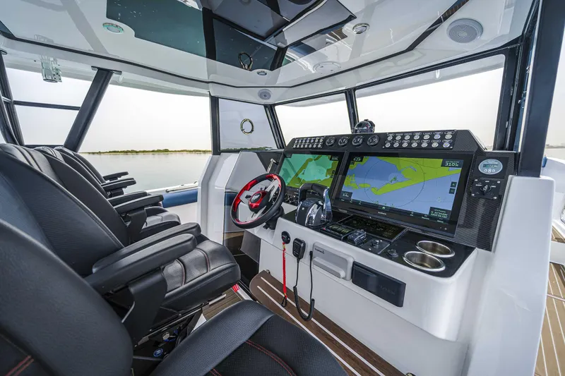Slide: The Image of Modern cockpit of 2025 Custom SilverCAT 40CC boat with advanced navigation systems. - 2