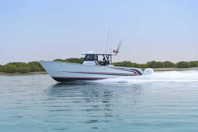 Slide: The Image of 2025 Custom SilverCAT 40CC boat cruising on calm water, side view. - 25