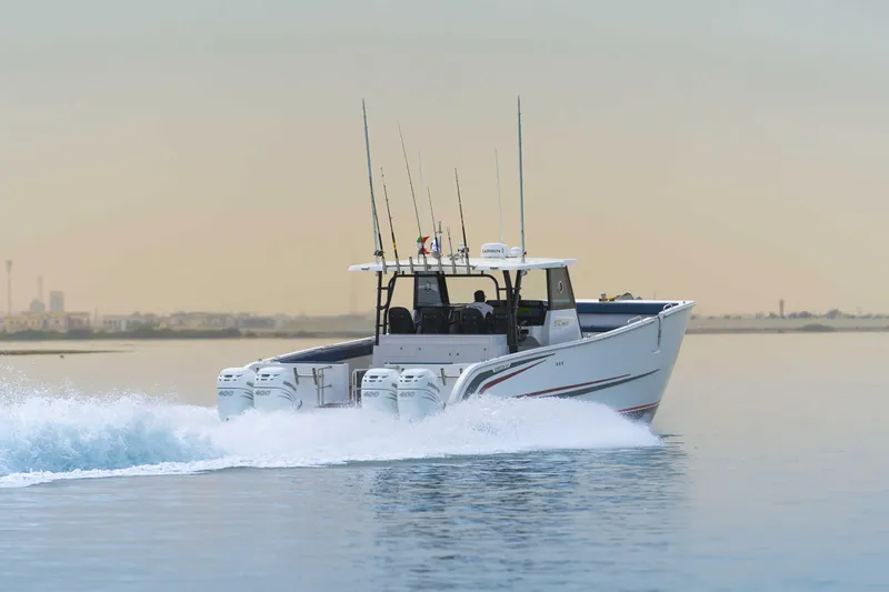 Slide: The Image of Custom SilverCAT 40CC 2025 boat cruising on calm water at sunset. - 28