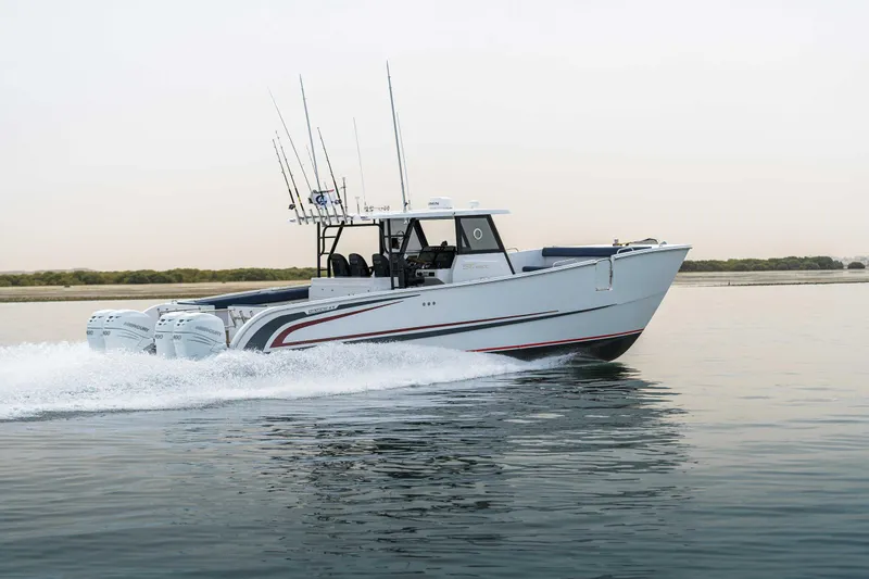 Slide: The Image of Custom SilverCAT 40CC 2025 boat cruising on calm water with multiple outboard engines. - 29