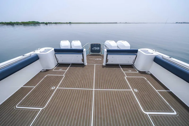 Slide: The Image of 2025 Custom SilverCAT 40CC boat deck with sleek design and powerful engines on calm water. - 3