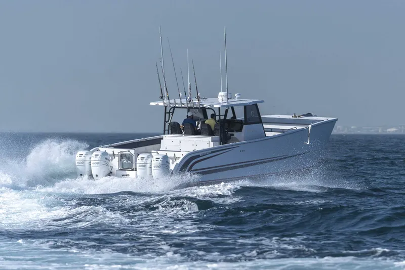 Slide: The Image of Custom SilverCAT 40CC 2025 boat cruising on open water with multiple outboard engines. - 31