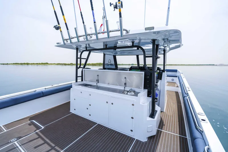 Slide: The Image of Custom SilverCAT 40CC 2025 boat with fishing rods and spacious deck on calm water. - 8