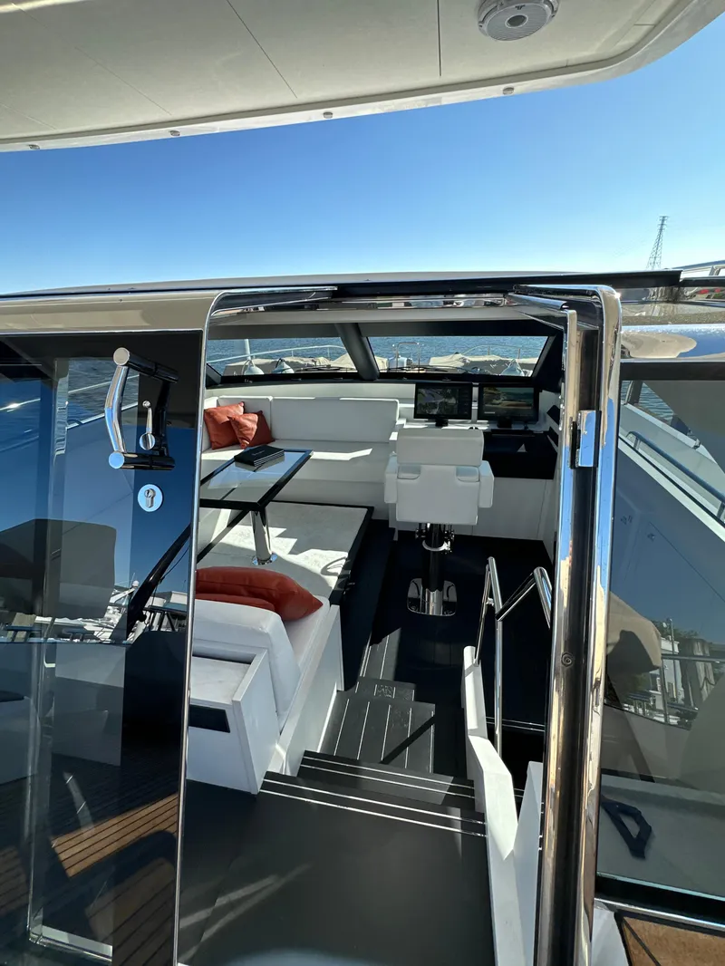 Slide: The Image of Interior view of 2019 Van der Valk BeachClub 600 yacht, featuring modern seating and navigation area. - 18