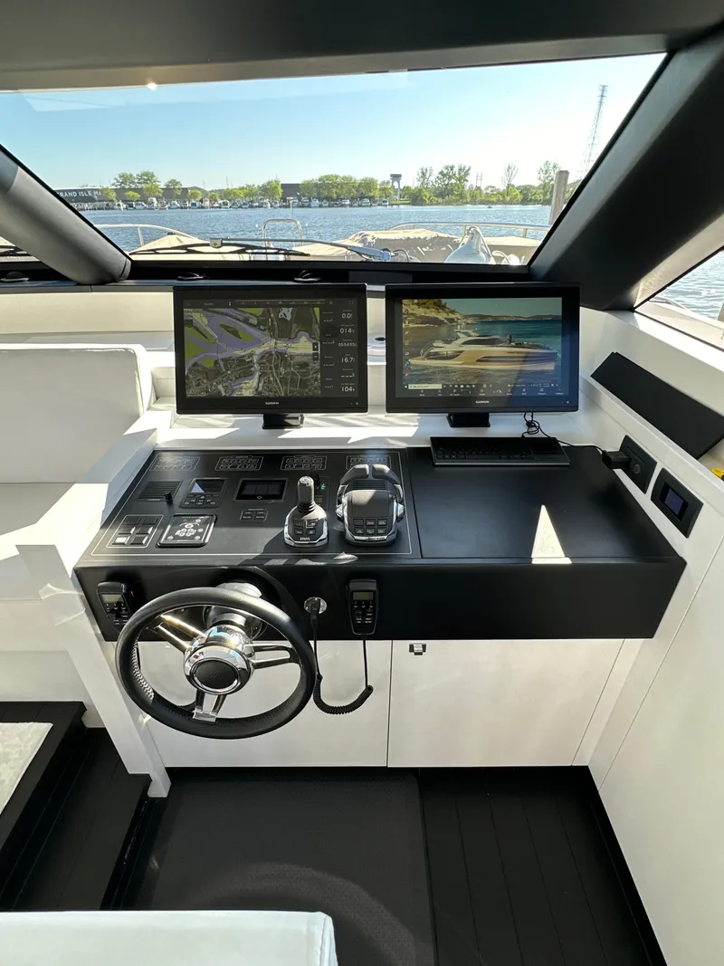Slide: The Image of Cockpit of 2019 Van der Valk BeachClub 600 yacht with dual navigation screens and steering wheel. - 20