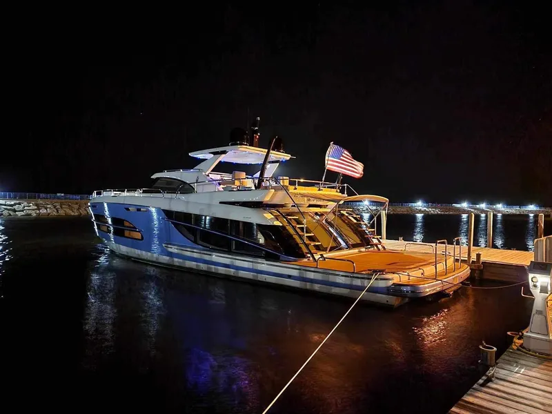 Slide: The Image of Luxurious 2019 Van der Valk BeachClub 600 yacht docked at night with American flag. - 48