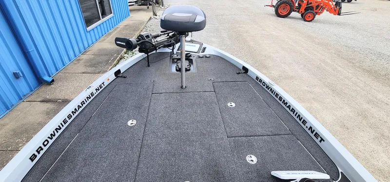 Slide: The Image of 2022 Ranger Z519 boat deck with fishing seat and trolling motor, near blue building. - 4