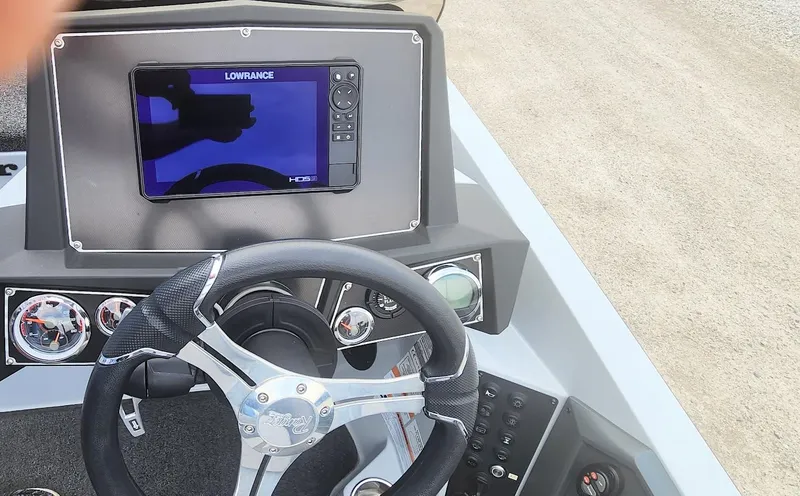 Slide: The Image of 2022 Ranger Z519 boat dashboard with steering wheel and Lowrance display. - 7