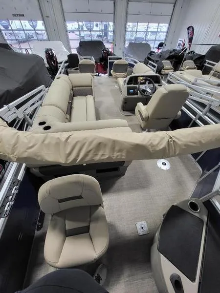 Slide: The Image of 2024 Sun Tracker Fishin Barge 20 DLX interior, featuring spacious seating and modern controls. - 12