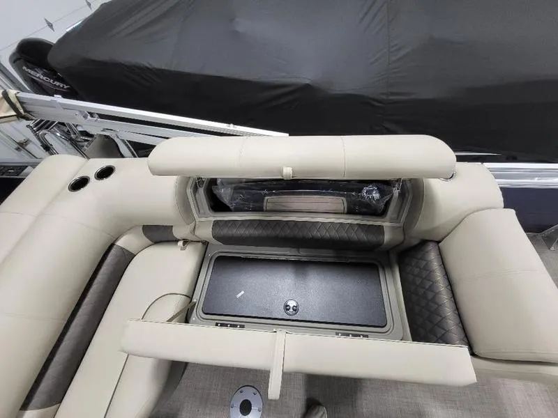 Slide: The Image of 2024 Sun Tracker Fishin Barge 20 DLX interior seating and storage compartment. - 8