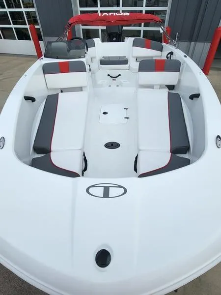 Slide: The Image of 2024 Tahoe T18 boat with red and gray seating, docked. - 10