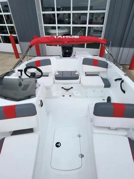 Slide: The Image of 2024 Tahoe T18 boat interior with red and gray seating, steering wheel, and canopy. - 2
