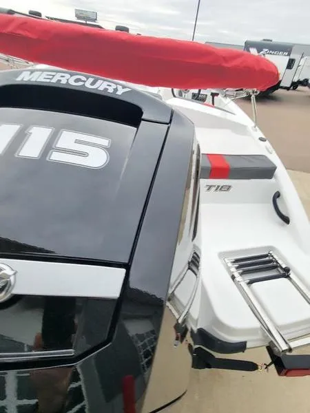 Slide: The Image of 2024 Tahoe T18 boat with Mercury 115 engine, red canopy, and swim platform. - 4