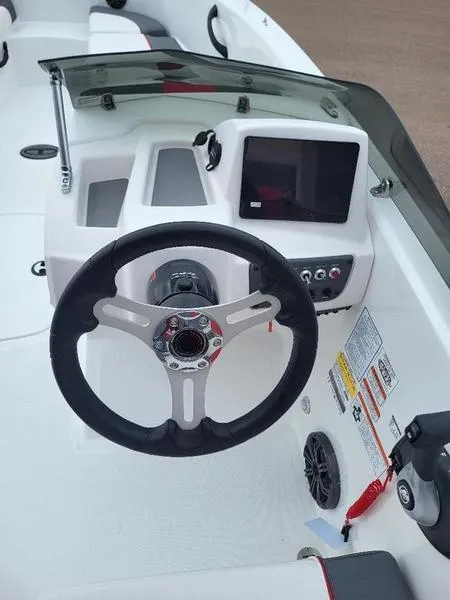 Slide: The Image of 2024 Tahoe T18 boat dashboard with steering wheel and control panel. - 6