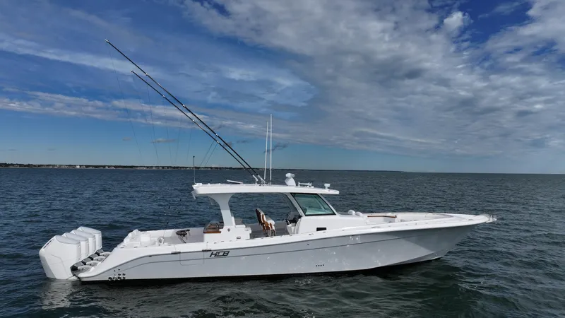 Slide: The Image of 2025 HCB 48 Campeon boat on open water under a partly cloudy sky. - 0
