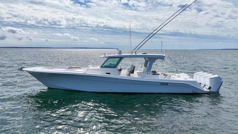 Slide: The Image of 2025 HCB 48 Campeon boat on calm water under cloudy sky. - 1