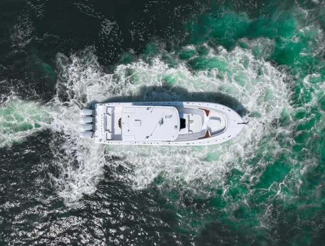 Slide: The Image of Aerial view of 2025 HCB 48 CAMPEON boat cruising through water. - 10