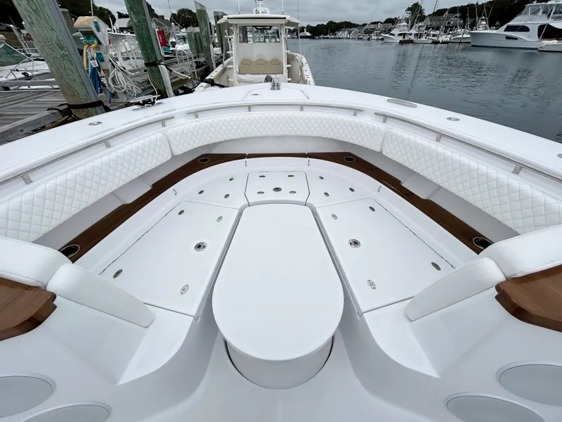 Slide: The Image of 2025 HCB 48 Campeon boat interior with white seating and storage compartments. - 14