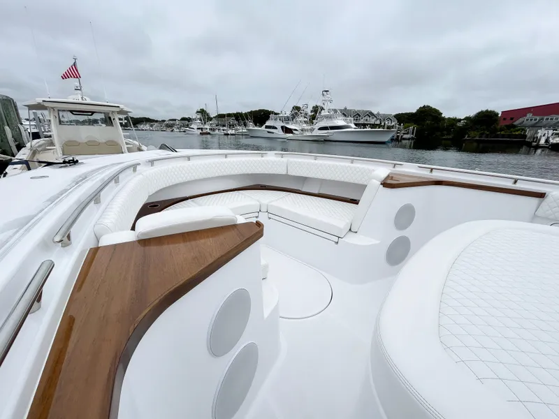 Slide: The Image of 2025 HCB 48 Campeon luxury boat with spacious seating and elegant design in a marina. - 16