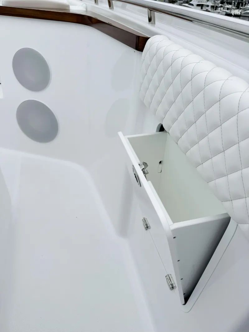 Slide: The Image of 2025 HCB 48 Campeon boat interior with quilted seating and storage compartment. - 19