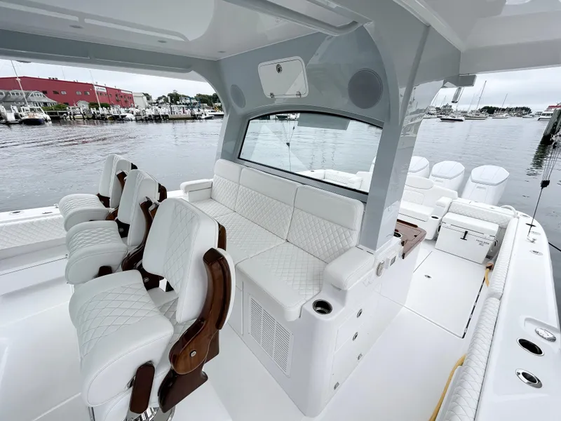 Slide: The Image of Luxurious 2025 HCB 48 Campeon boat interior with white seating and waterfront view. - 28