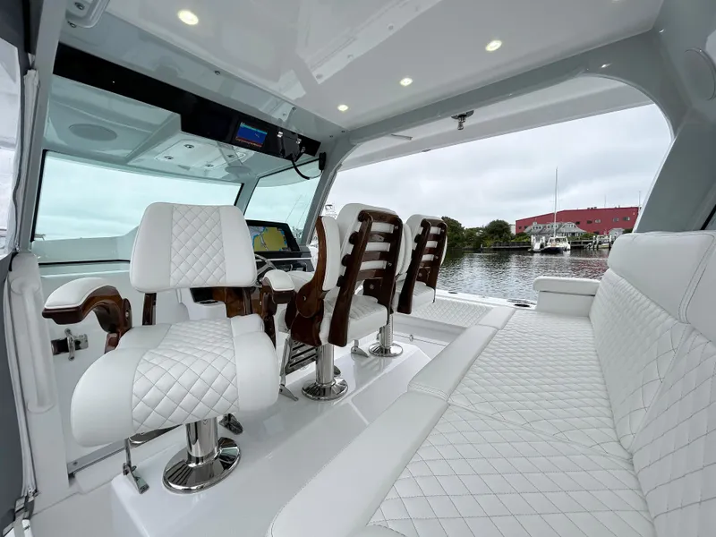 Slide: The Image of Luxurious interior of 2025 HCB 48 Campeon boat with white quilted seating. - 31