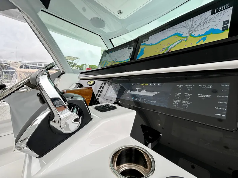 Slide: The Image of 2025 HCB 48 Campeon boat dashboard with navigation screens and controls. - 34